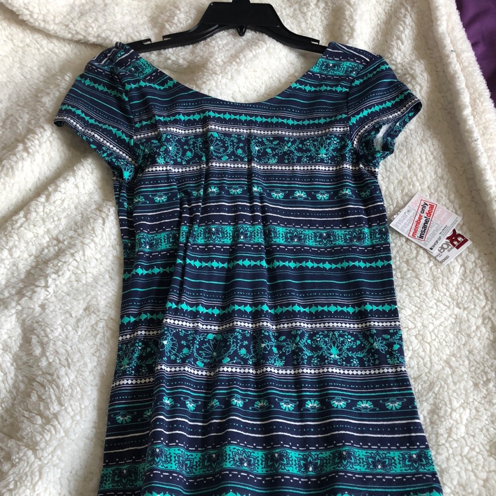 navy blue top with green and white detailing